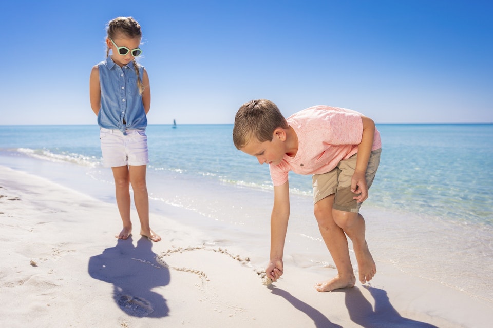 Kids searching seashells on Pensacola Beach